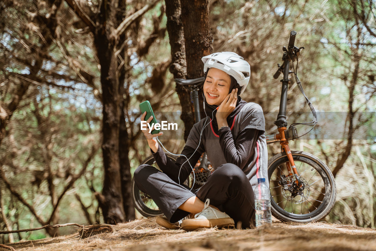 Side view of woman riding bicycle