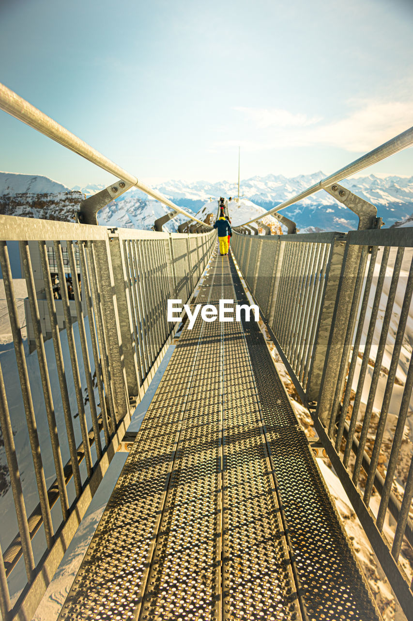 Footbridge against sky