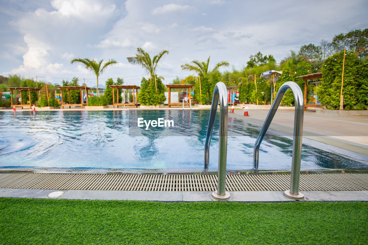 View of swimming pool against cloudy sky