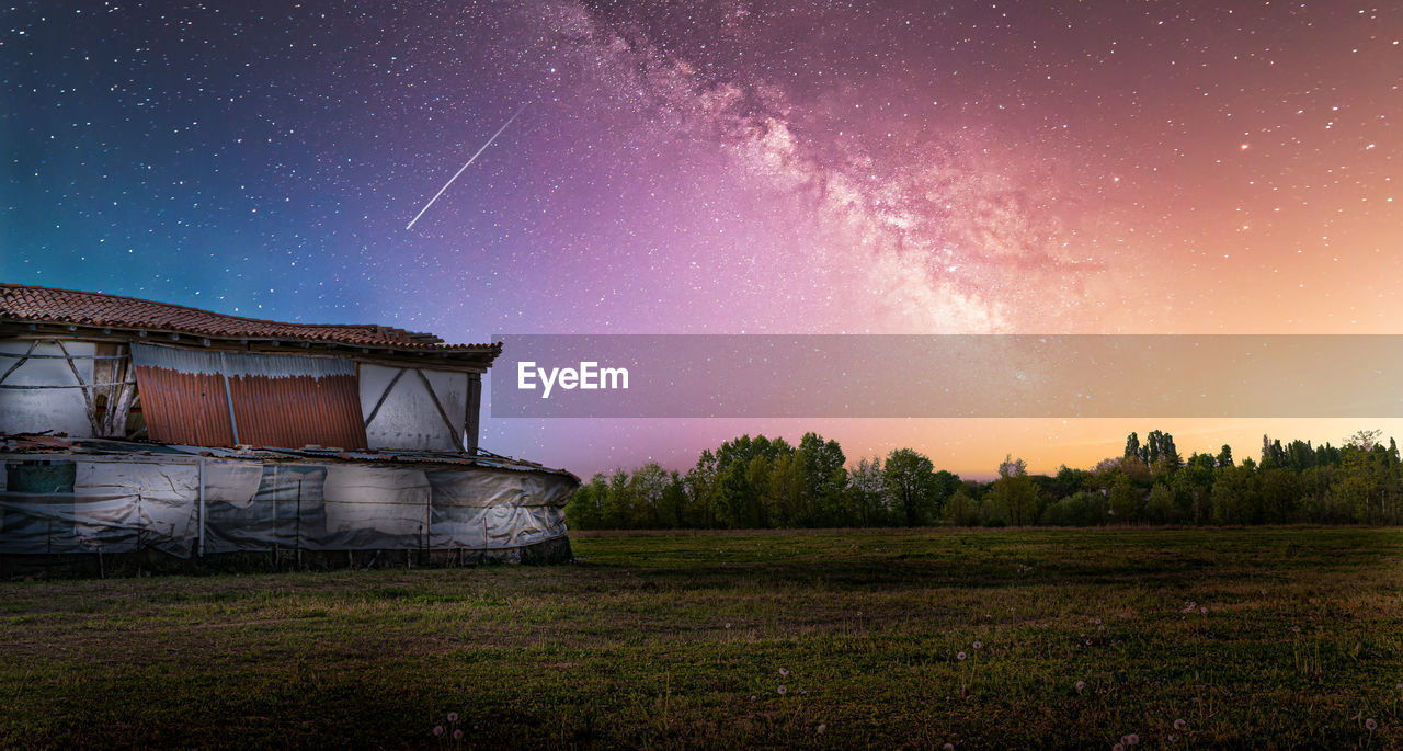 Scenic view of field against sky at night