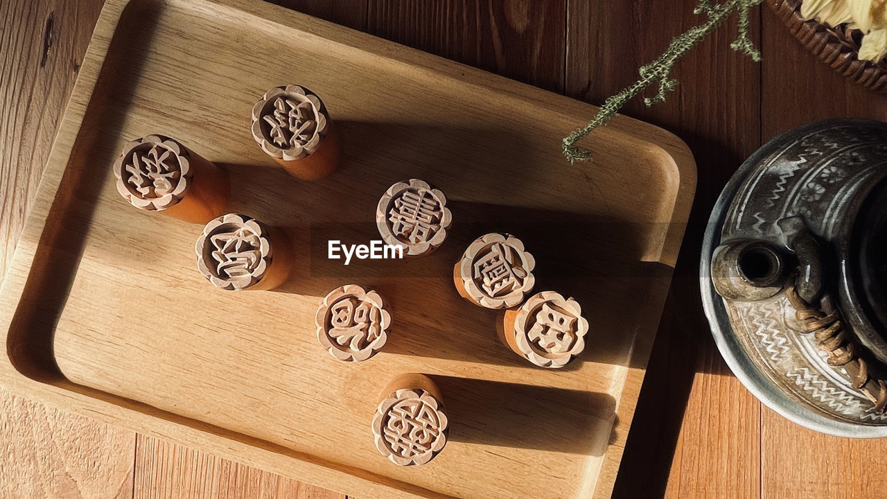 Tea cup with wooden alphabet stamp set on table, tea on table