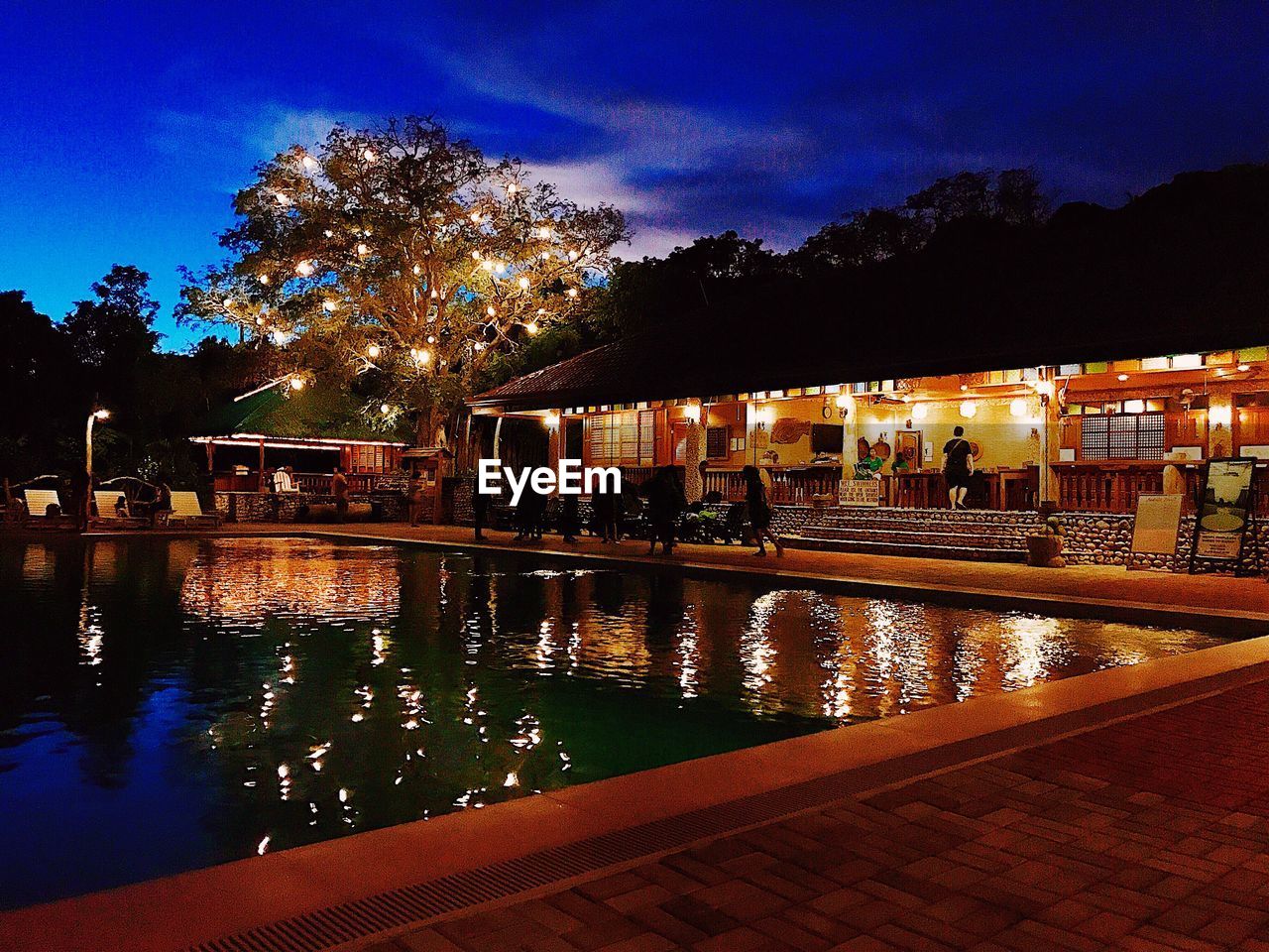 ILLUMINATED SWIMMING POOL AT NIGHT