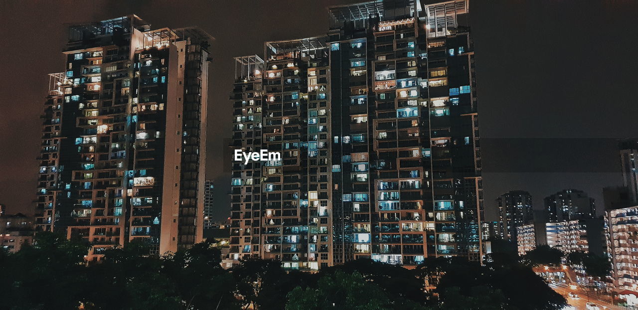 high angle view of illuminated buildings in city at night