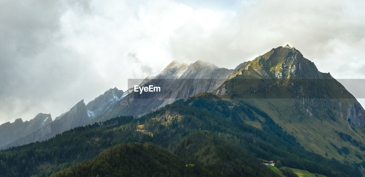 Scenic view of mountains against cloudy sky - mittersill, austria