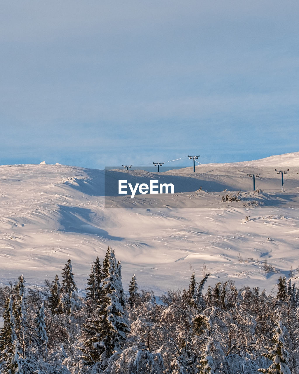 Scenic view of snow covered mountains against sky