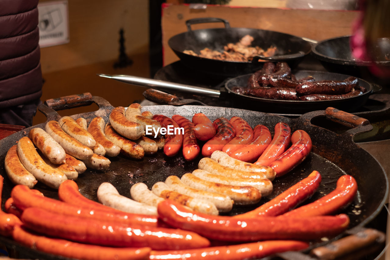 Different grilled sausages on a large skillet.
