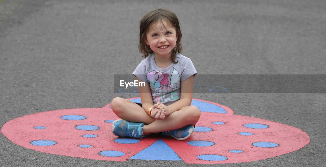 PORTRAIT OF A SMILING GIRL SITTING