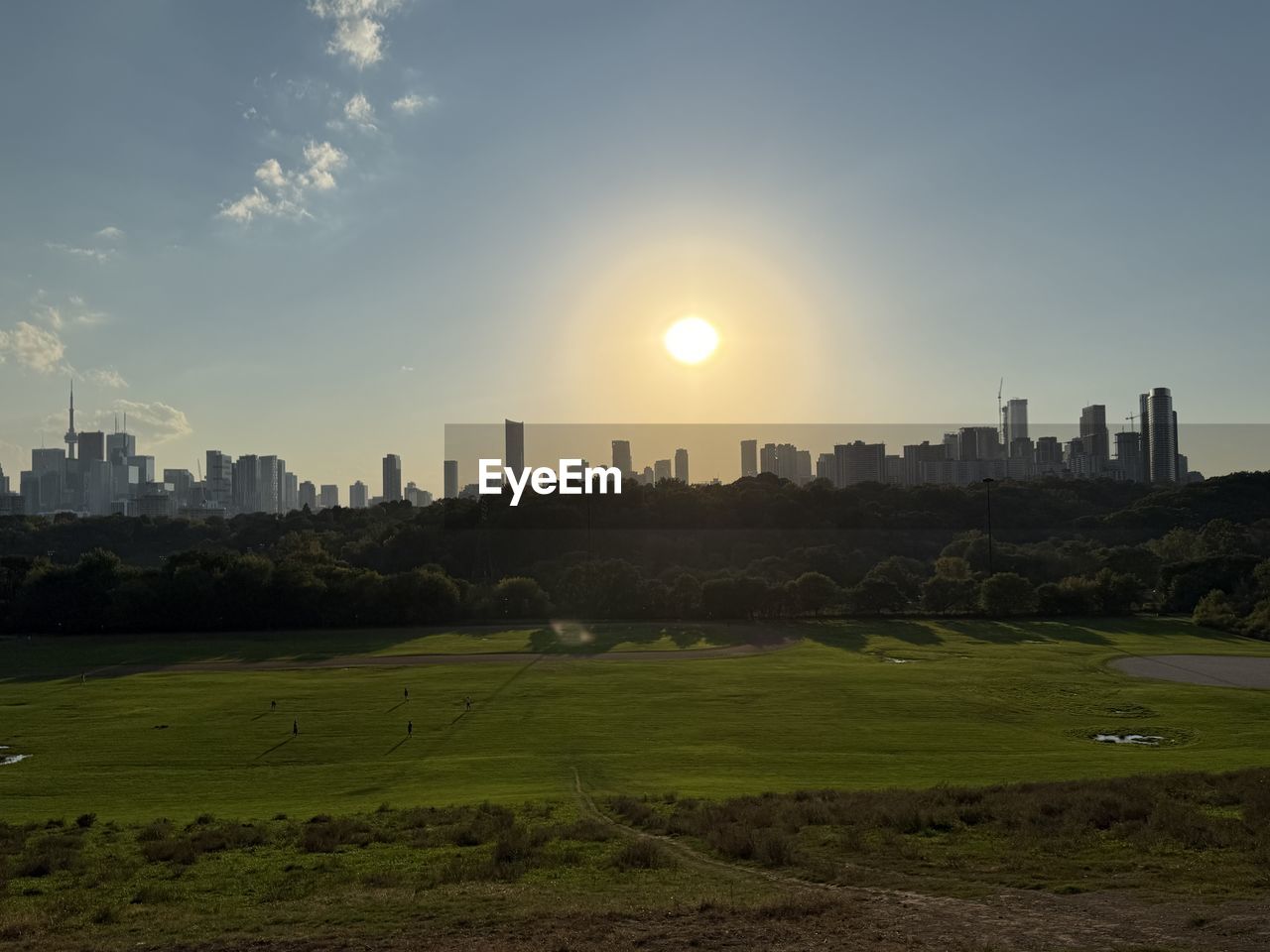 horizon, landscape, sky, architecture, city, building exterior, built structure, building, urban skyline, morning, skyscraper, office building exterior, nature, cityscape, environment, skyline, dusk, residential district, sunlight, grass, travel destinations, cloud, sun, no people, travel, outdoors, hill, scenics - nature, plain, city life, plant, land, rural area, field, downtown district, tree, beauty in nature, tranquility