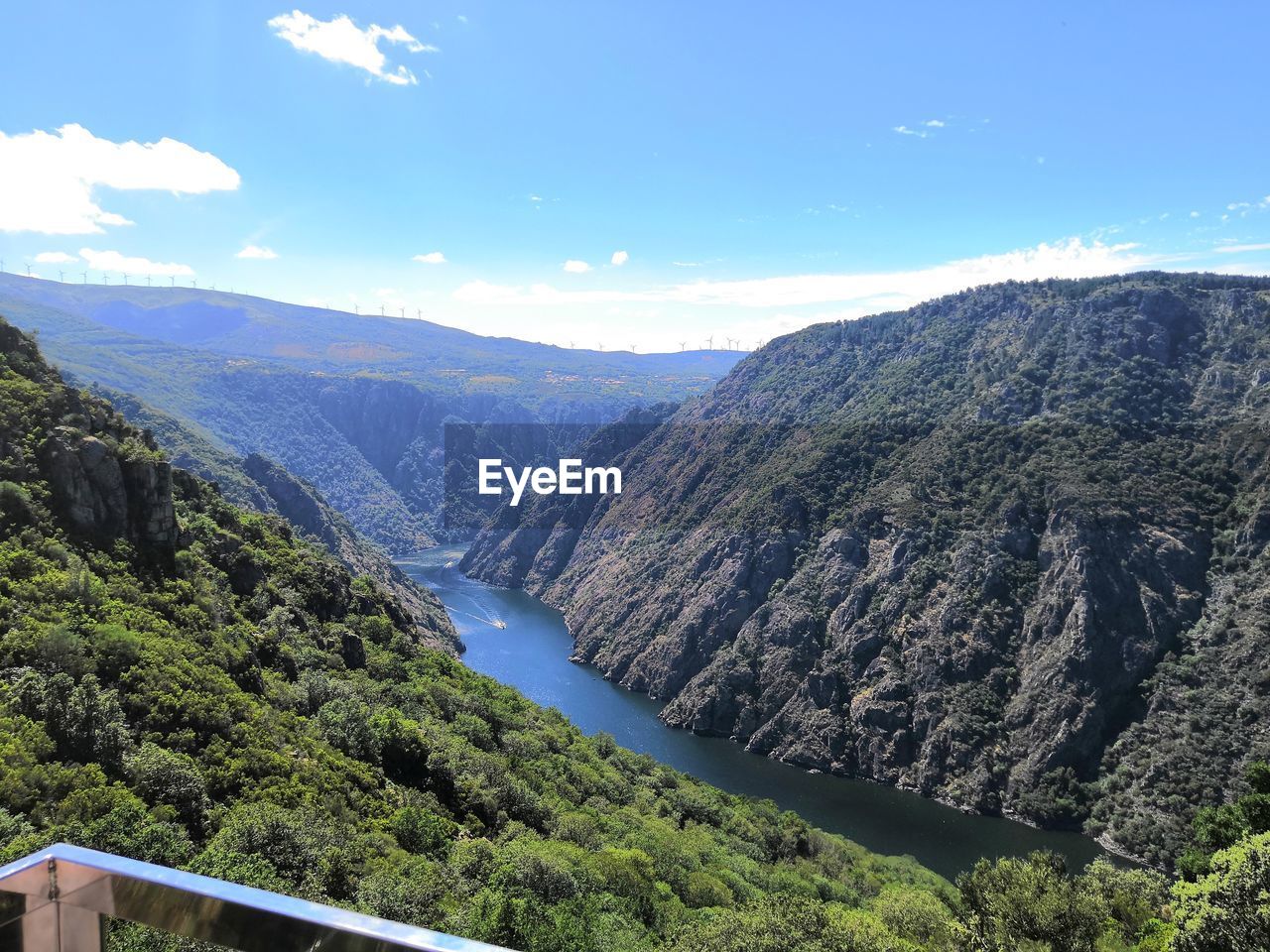 Scenic view of river amidst mountains against sky