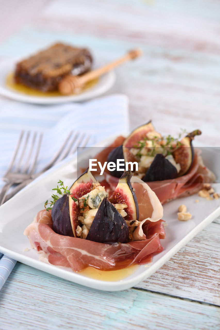 Figs stuffed with blue cheese, wrapped in parma ham, drizzled with honey