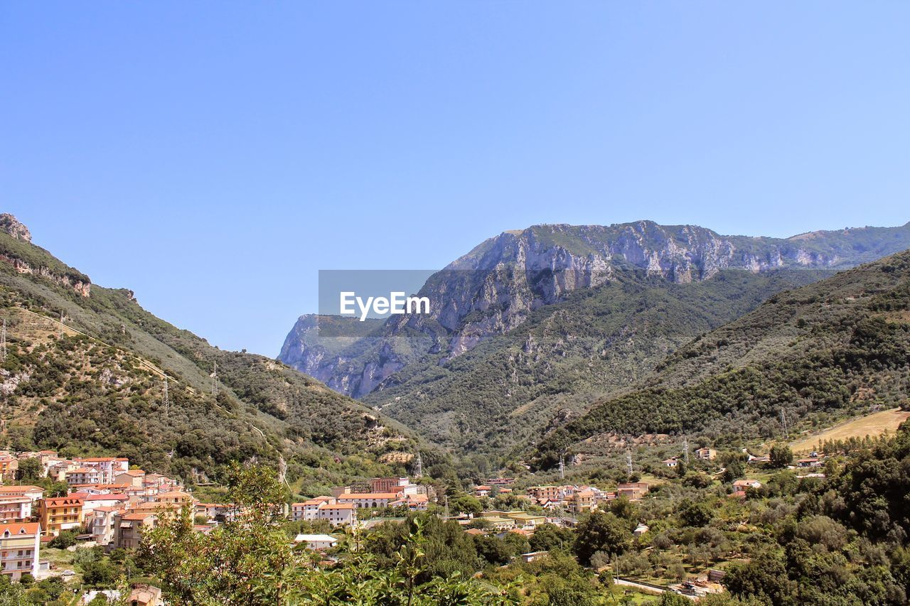 Scenic view of mountains against clear blue sky