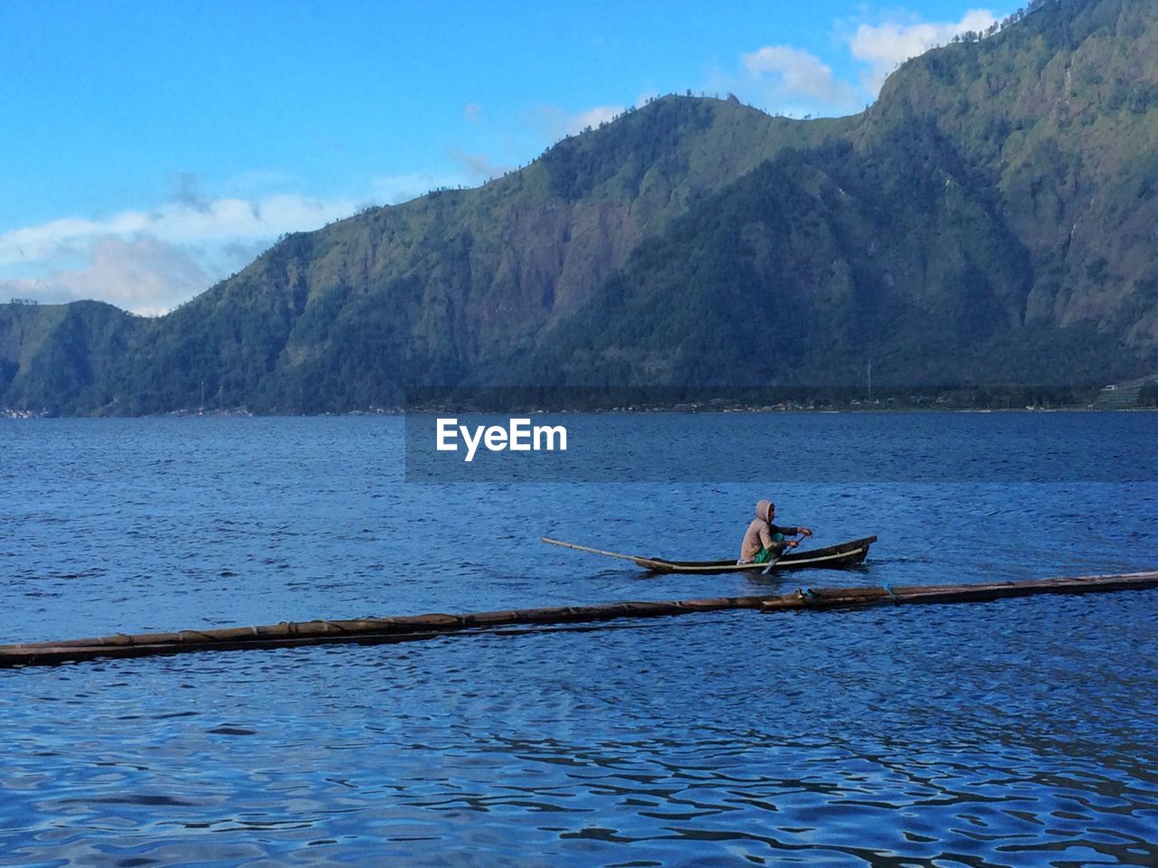 Boat sailing in lake against sky