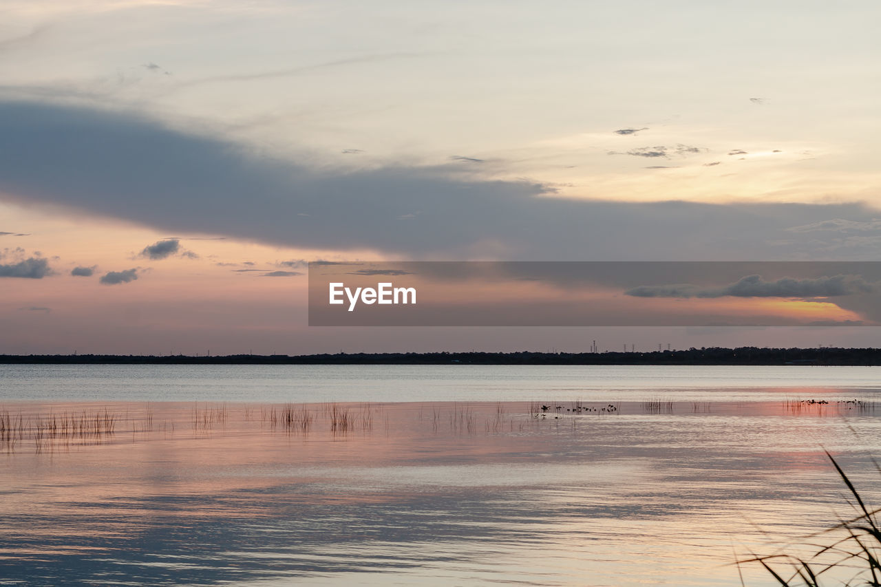 SCENIC VIEW OF SEA AGAINST ORANGE SKY