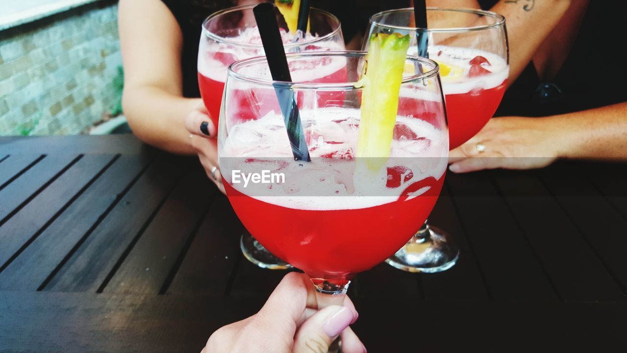 Close-up of friends with cocktail glasses