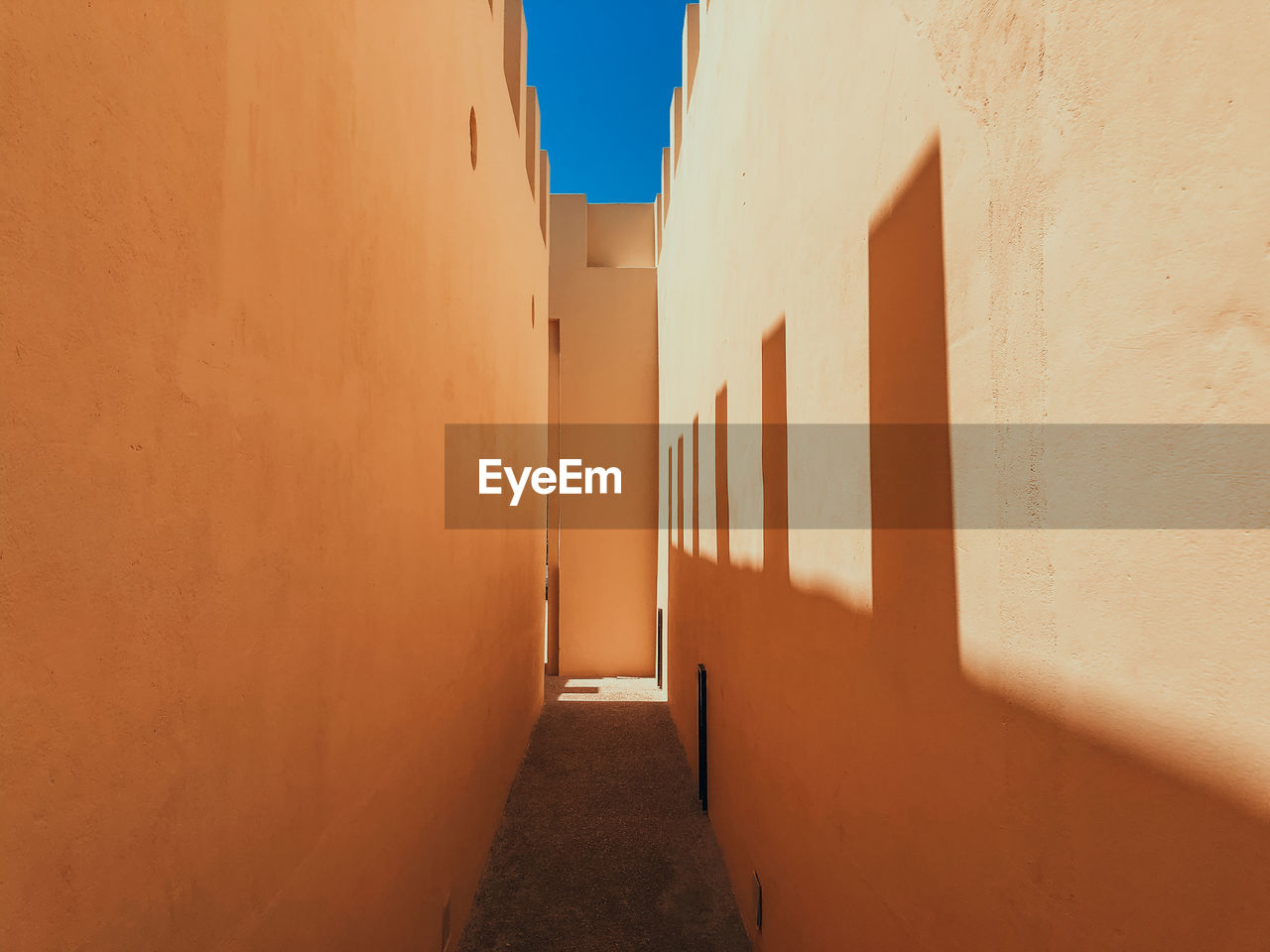 Traditional architecture in light and shadows. empty old alley amidst buildings