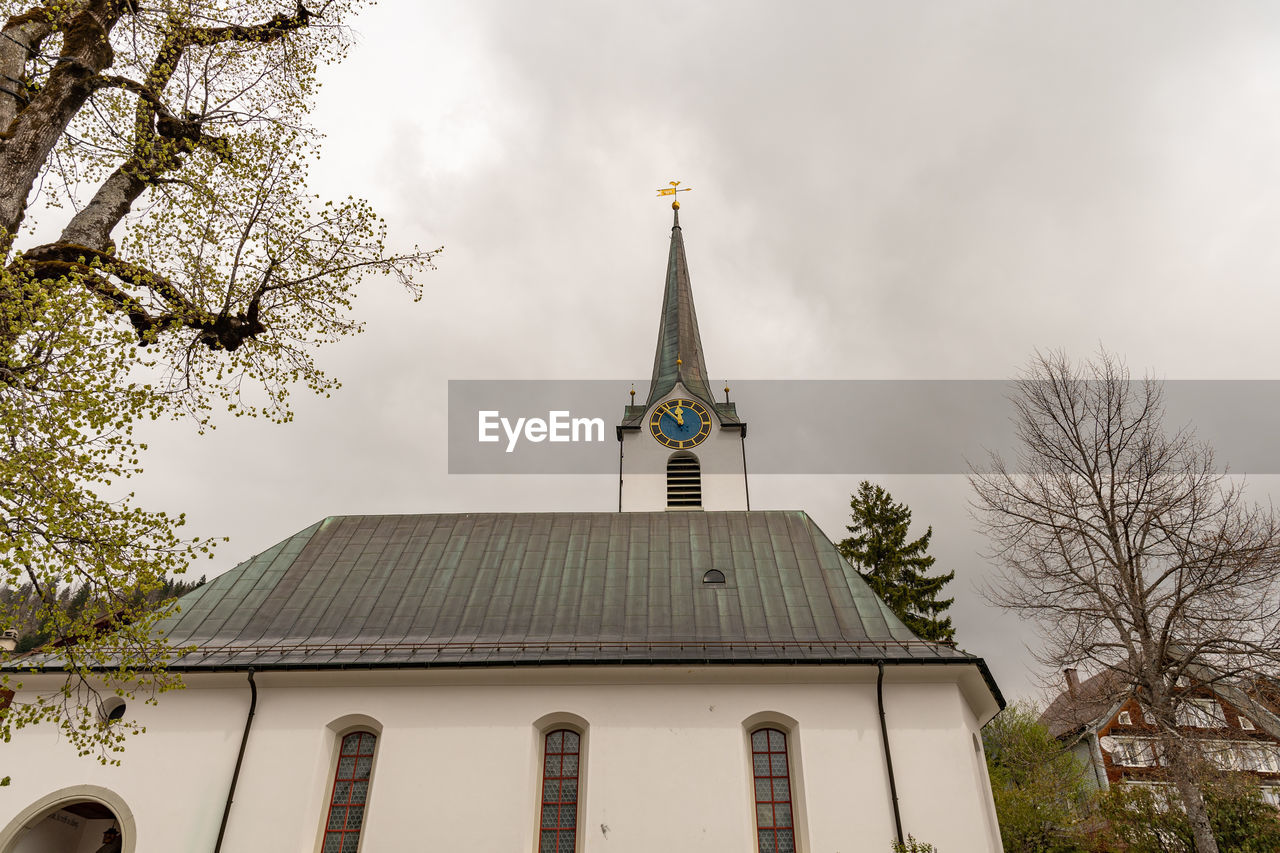 Wildhaus, switzerland, may 5, 2022 catholic church in the center on an overcast day in spring time