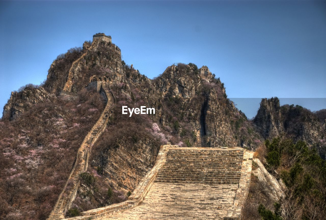 Great wall of china and mountain against blue sky