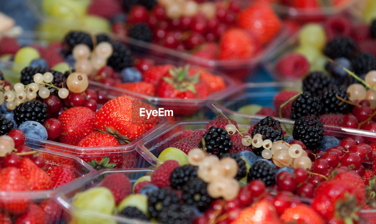 High angle view of fruits in containers at market stall