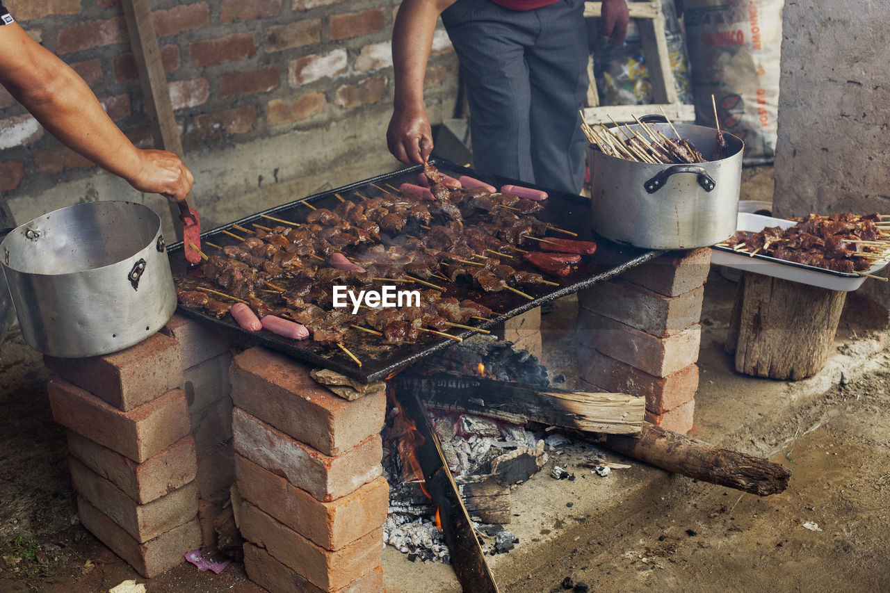 cropped hand of man preparing food