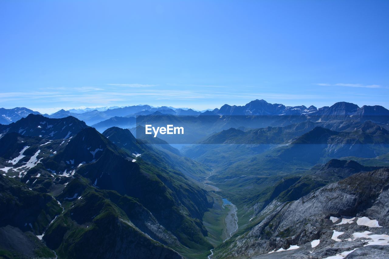 Scenic view of mountains against clear blue sky