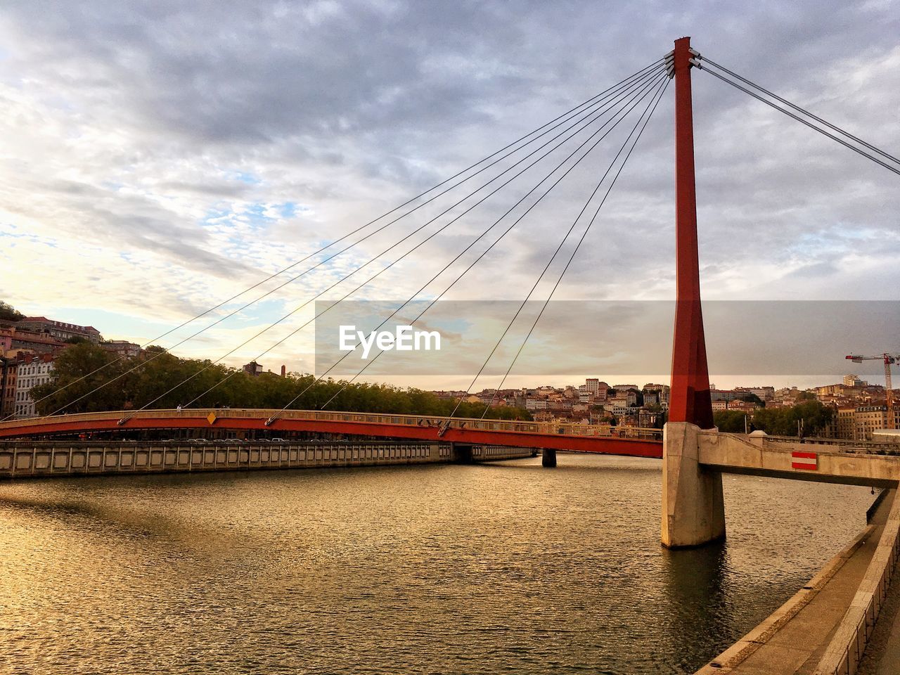 VIEW OF SUSPENSION BRIDGE OVER RIVER