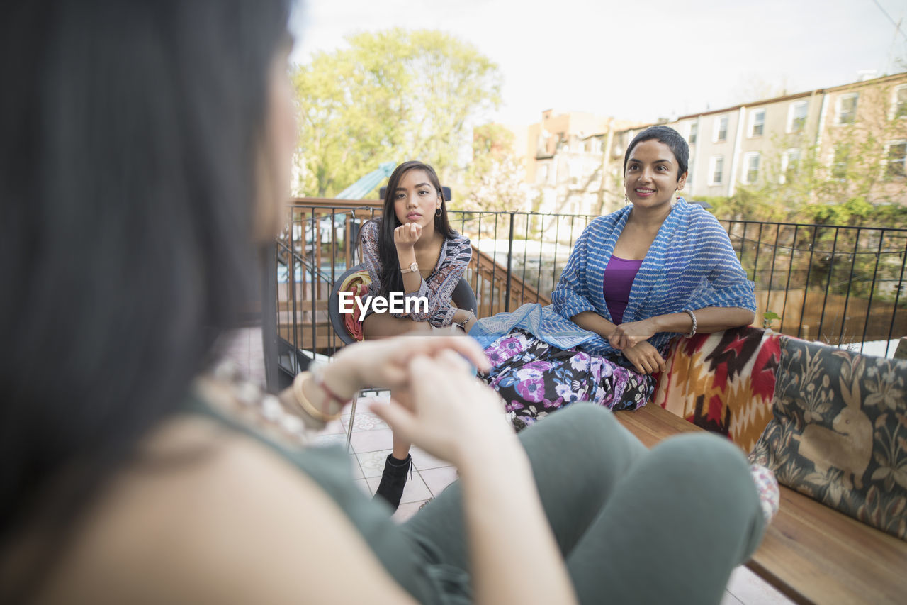 Young women talking at a party