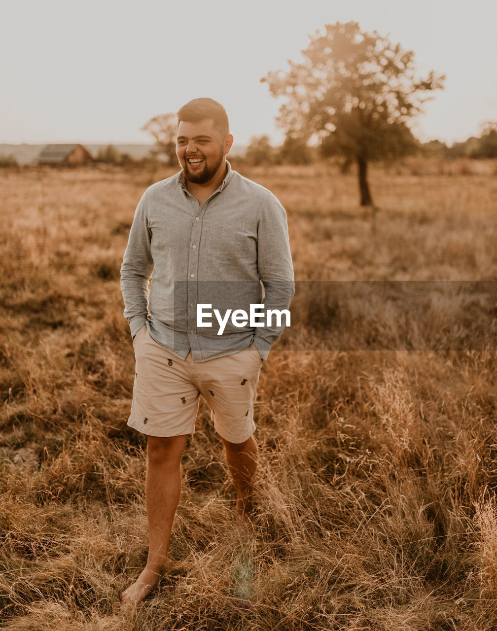 portrait of man standing on field