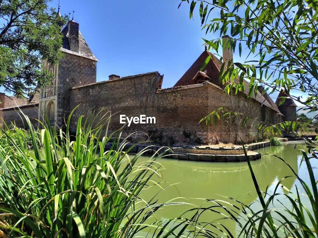 CANAL BY BUILDING AGAINST CLEAR SKY