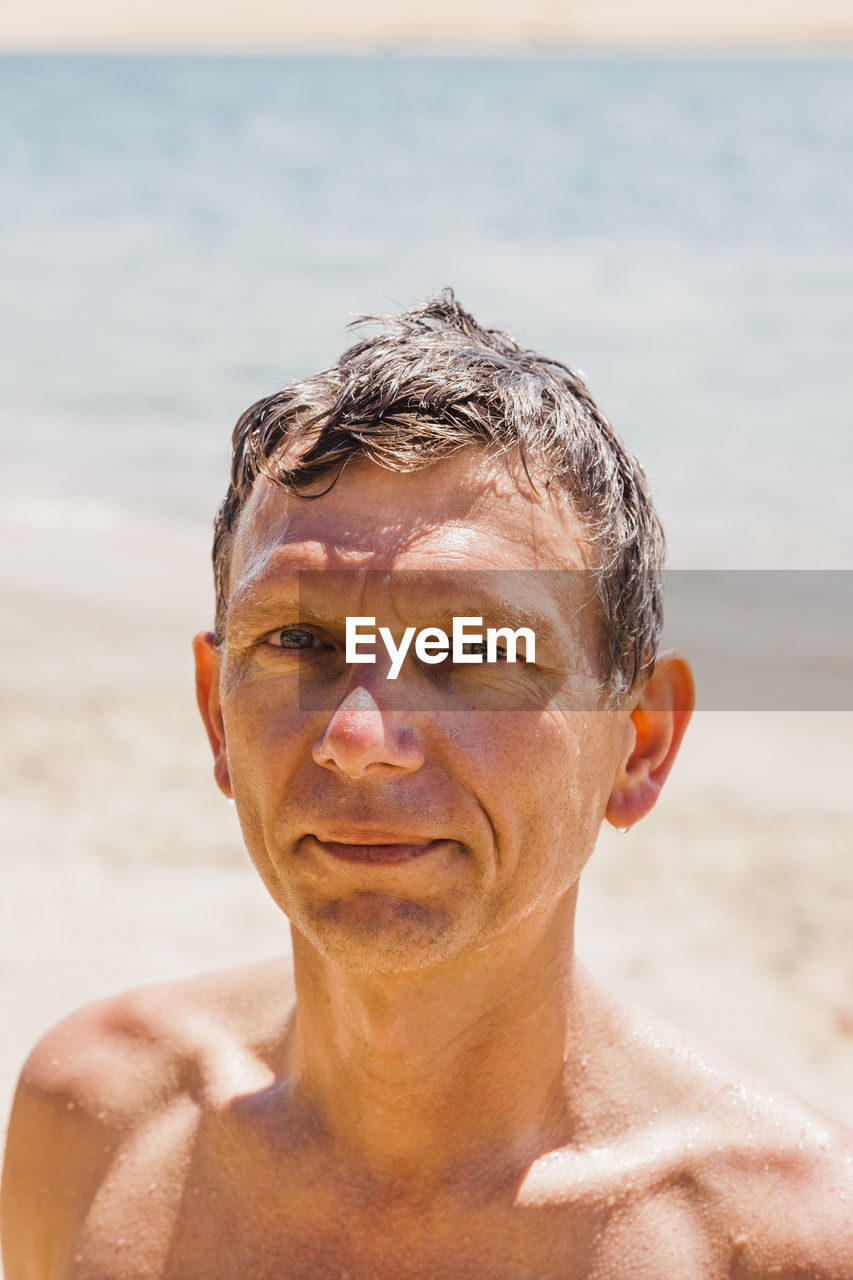 Portrait of shirtless man at beach