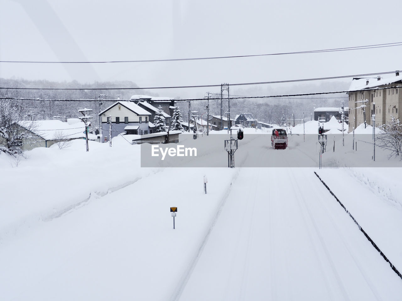 SNOW COVERED RAILROAD TRACKS AGAINST MOUNTAIN