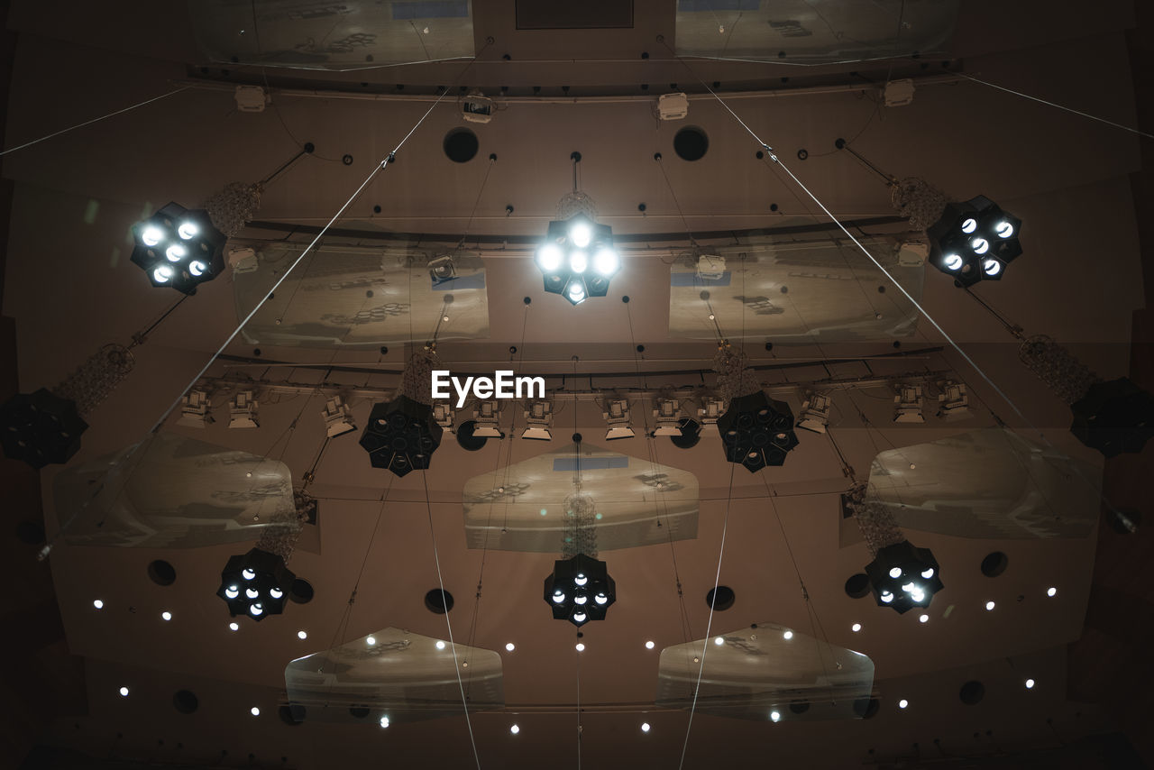 lighting equipment, ceiling, indoors, light, lighting, hanging, no people, illuminated, space, chandelier, stage, low angle view