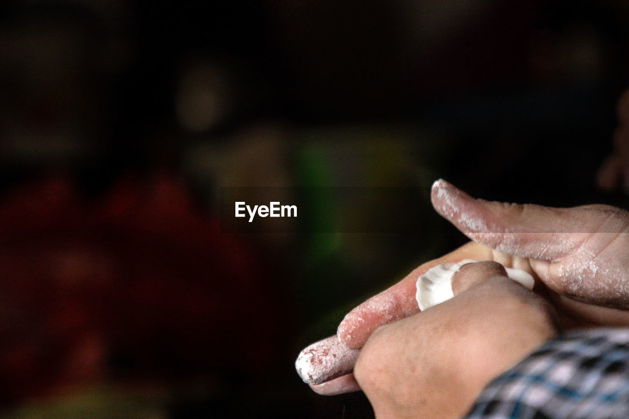 Cropped hands of man making dumplings in kitchen