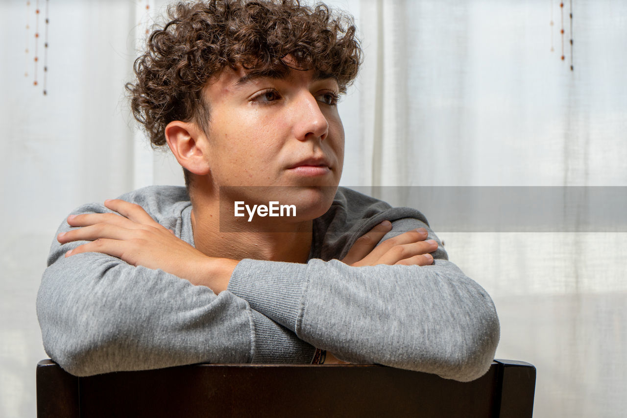 Portrait of young man sitting at home