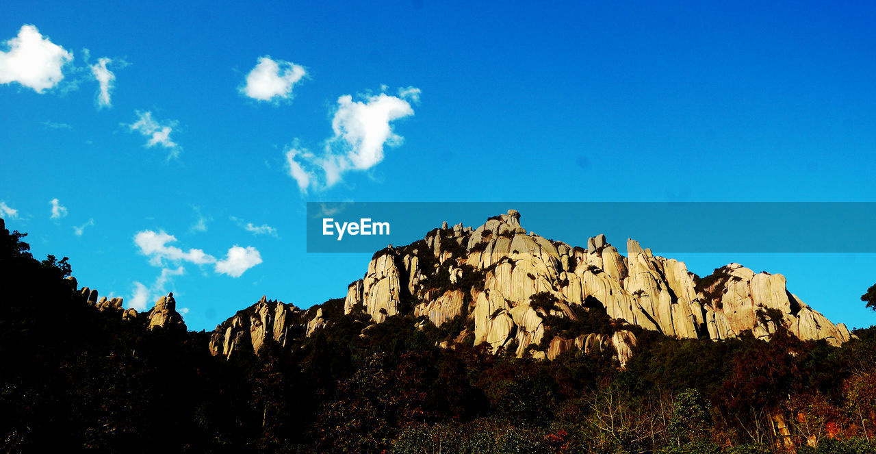 LOW ANGLE VIEW OF ROCK FORMATION AGAINST SKY