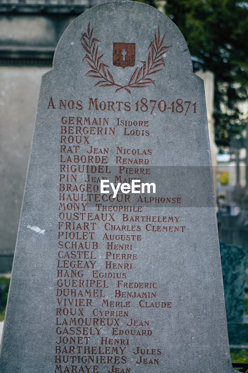 CLOSE-UP OF CROSS ON CEMETERY