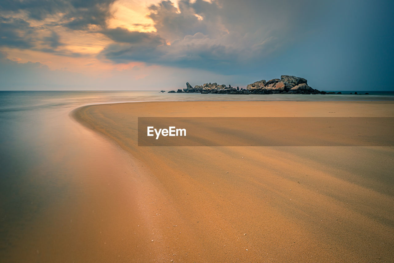 Scenic view of beach against sky during sunset