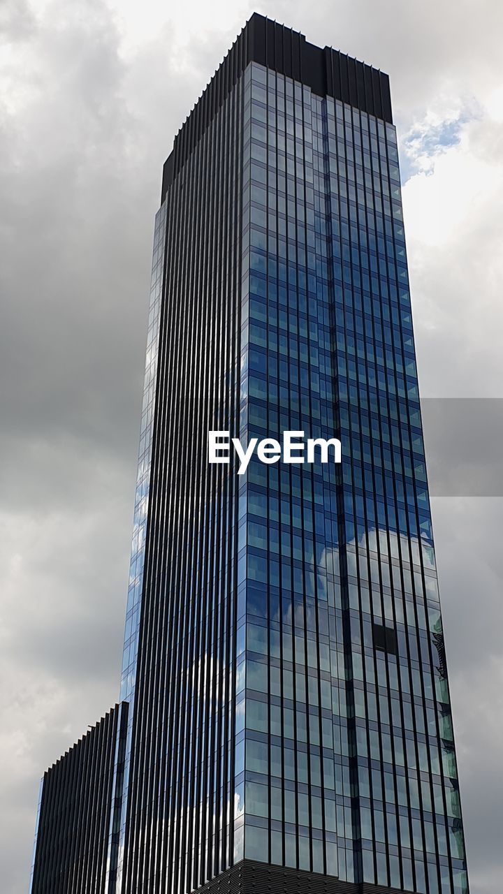 Low angle view of skyscraper against sky