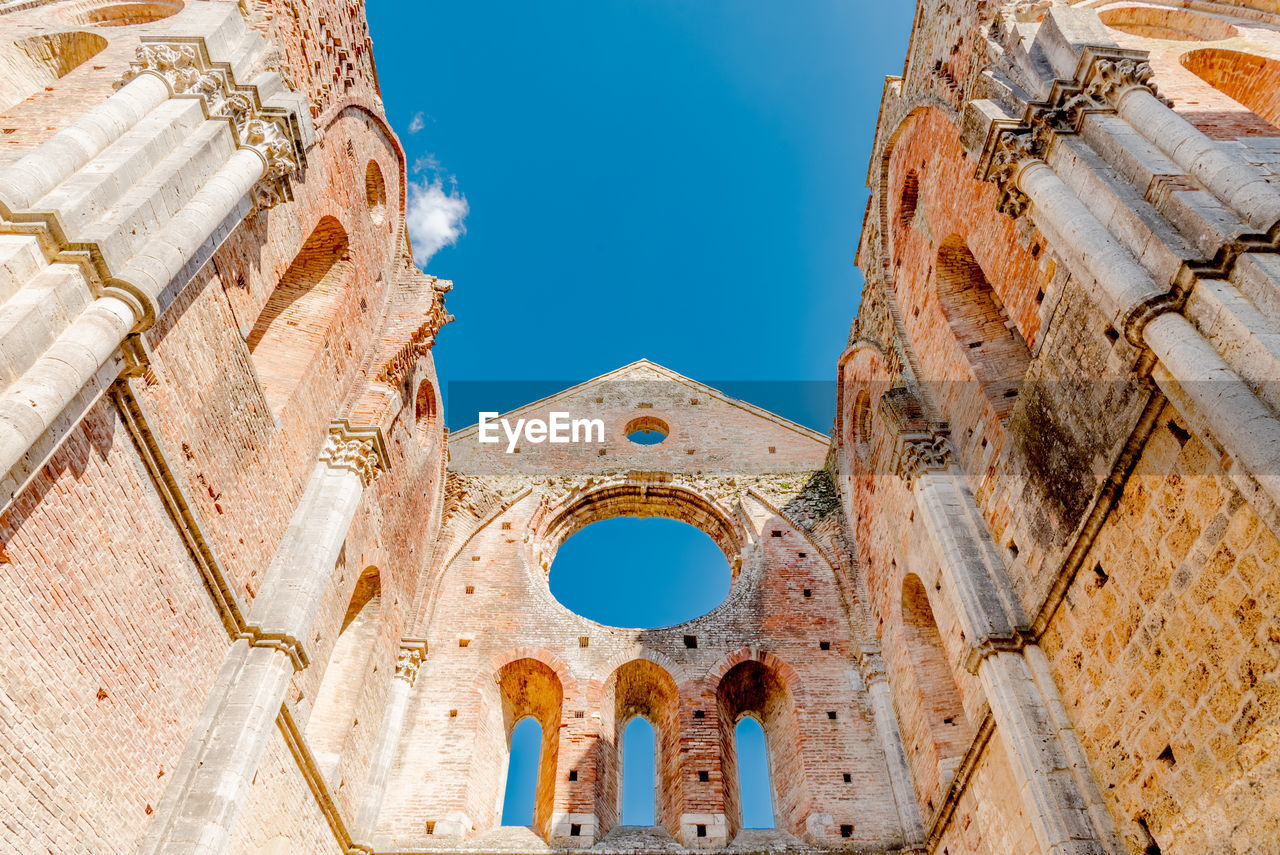 Low angle view of historical building against blue sky