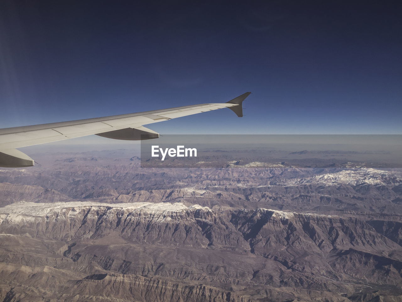 Aerial view of airplane flying over landscape