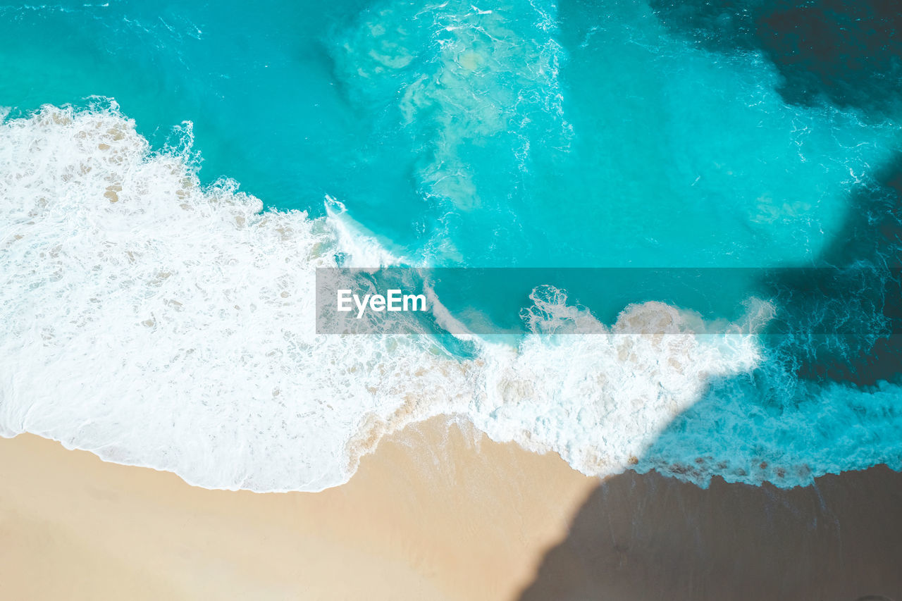 High angle view of waves splashing on sea