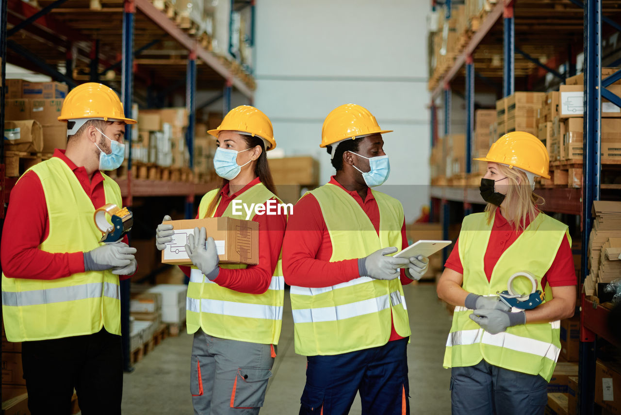 Construction engineers with tablet in warehouse