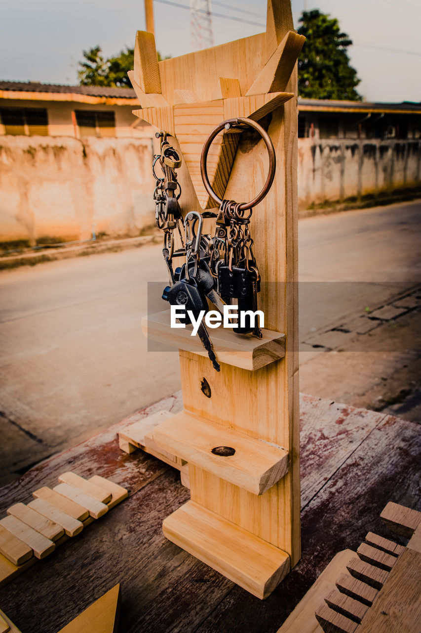 Close-up of keys hanging on wood in city