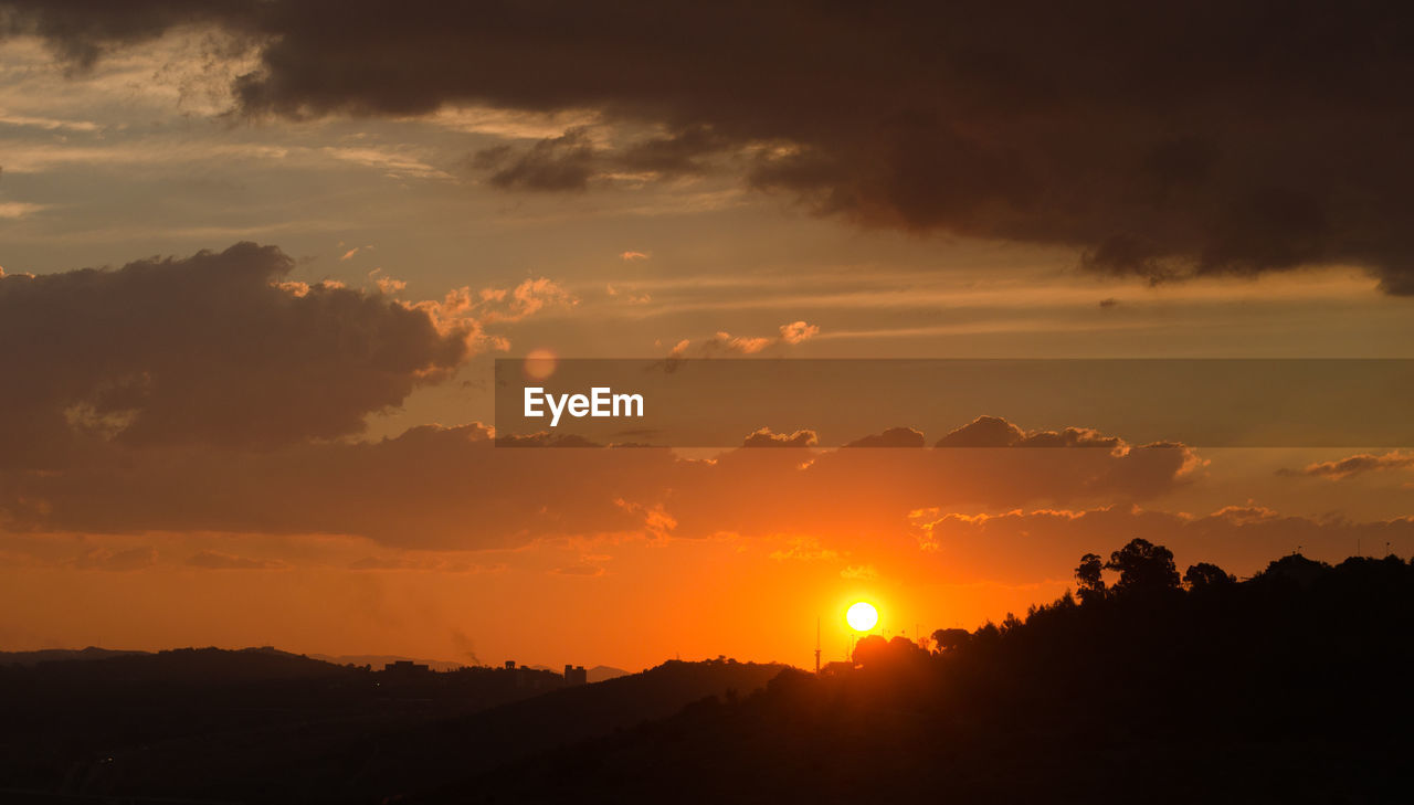 Scenic view of silhouette landscape against sky during sunset