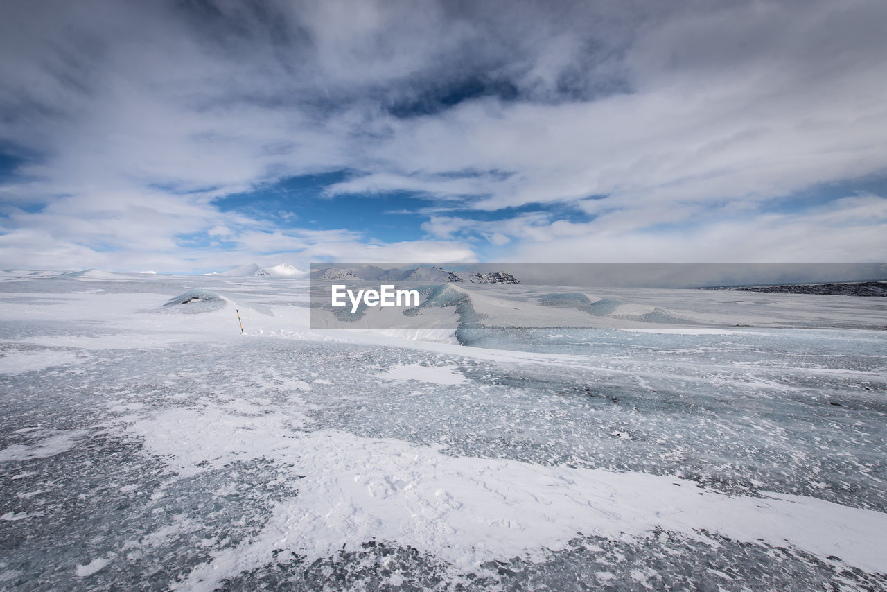 Scenic view of snowcapped landscape against sky