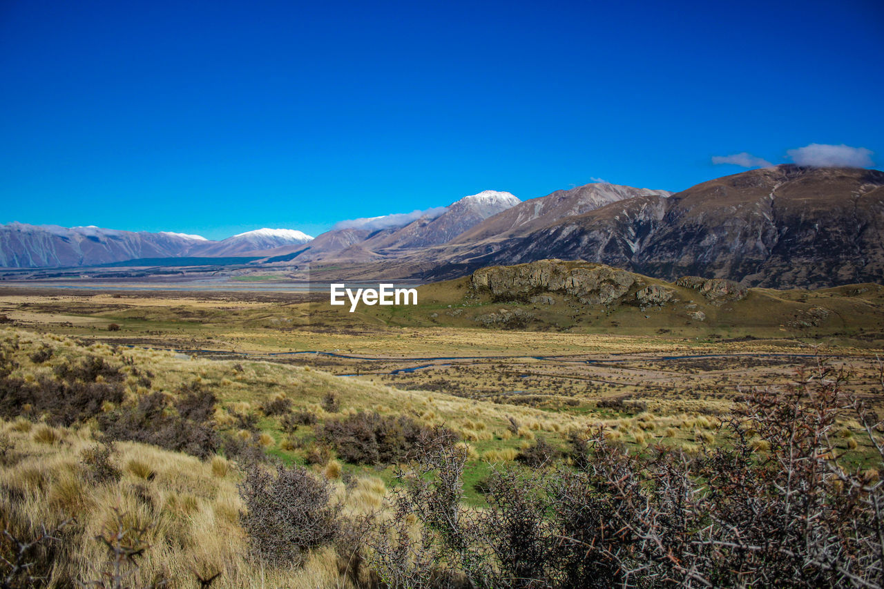 Scenic view of landscape against clear blue sky