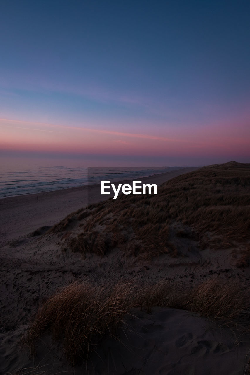 SCENIC VIEW OF LAND AGAINST SKY DURING SUNSET