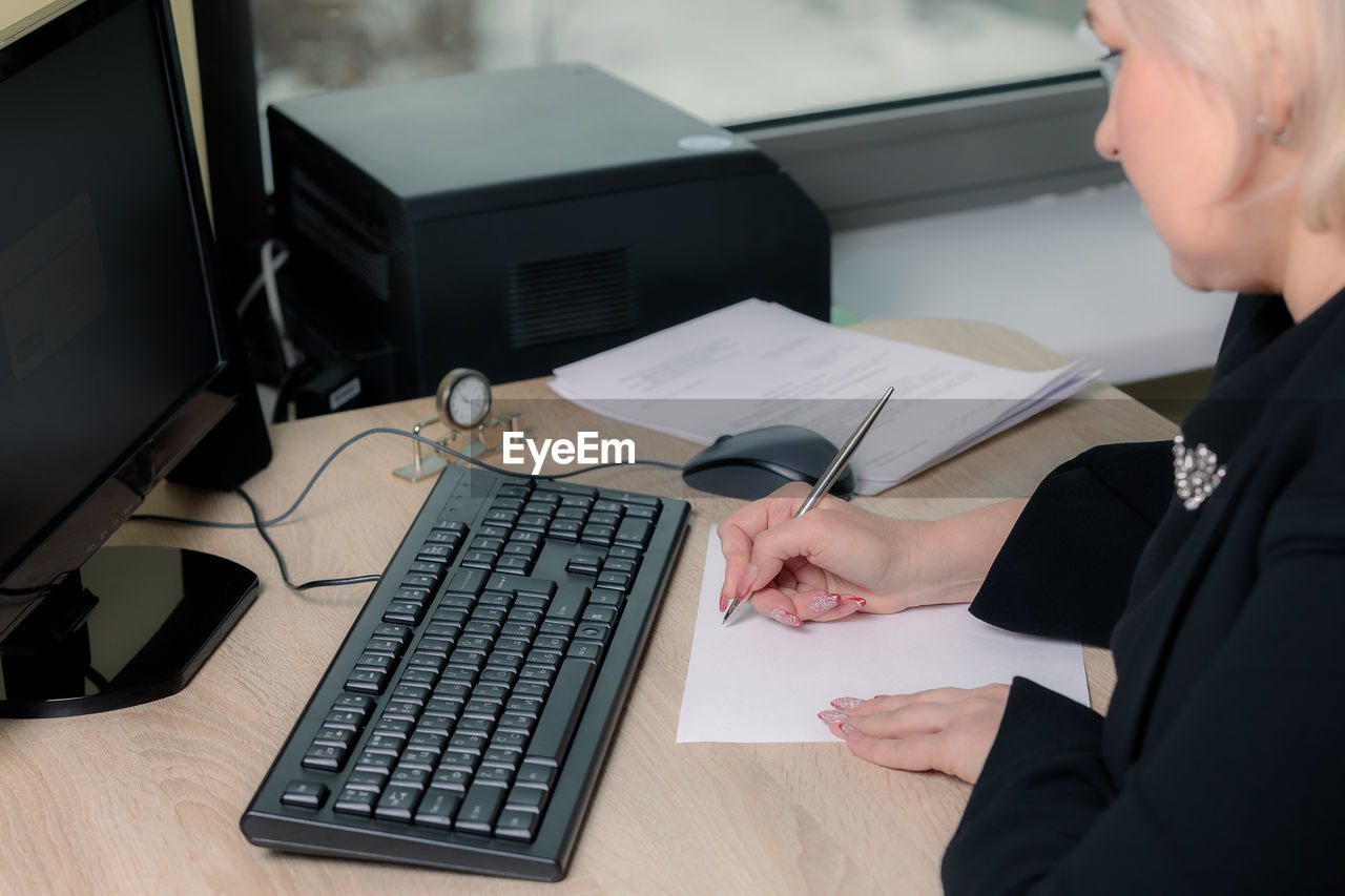 Midsection of woman working on table