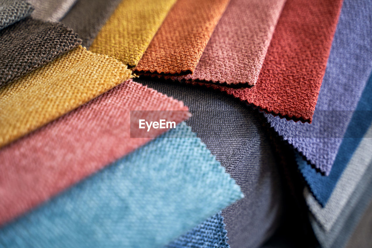 textile, multi colored, close-up, no people, backgrounds, variation, full frame, clothing, blue, indoors, retail, selective focus, business, art, pattern, fashion, industry, material, textile industry, red, business finance and industry