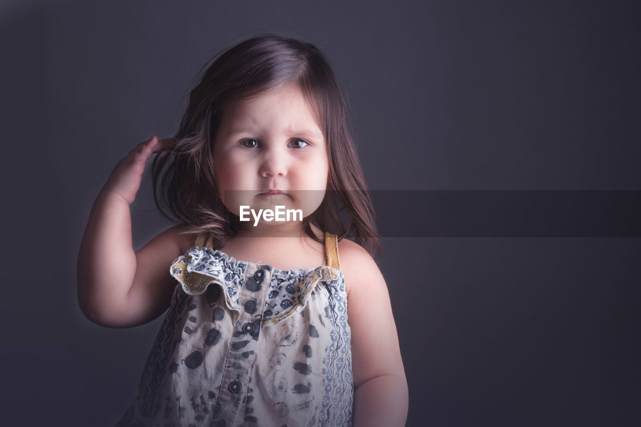 Portrait of girl against gray background