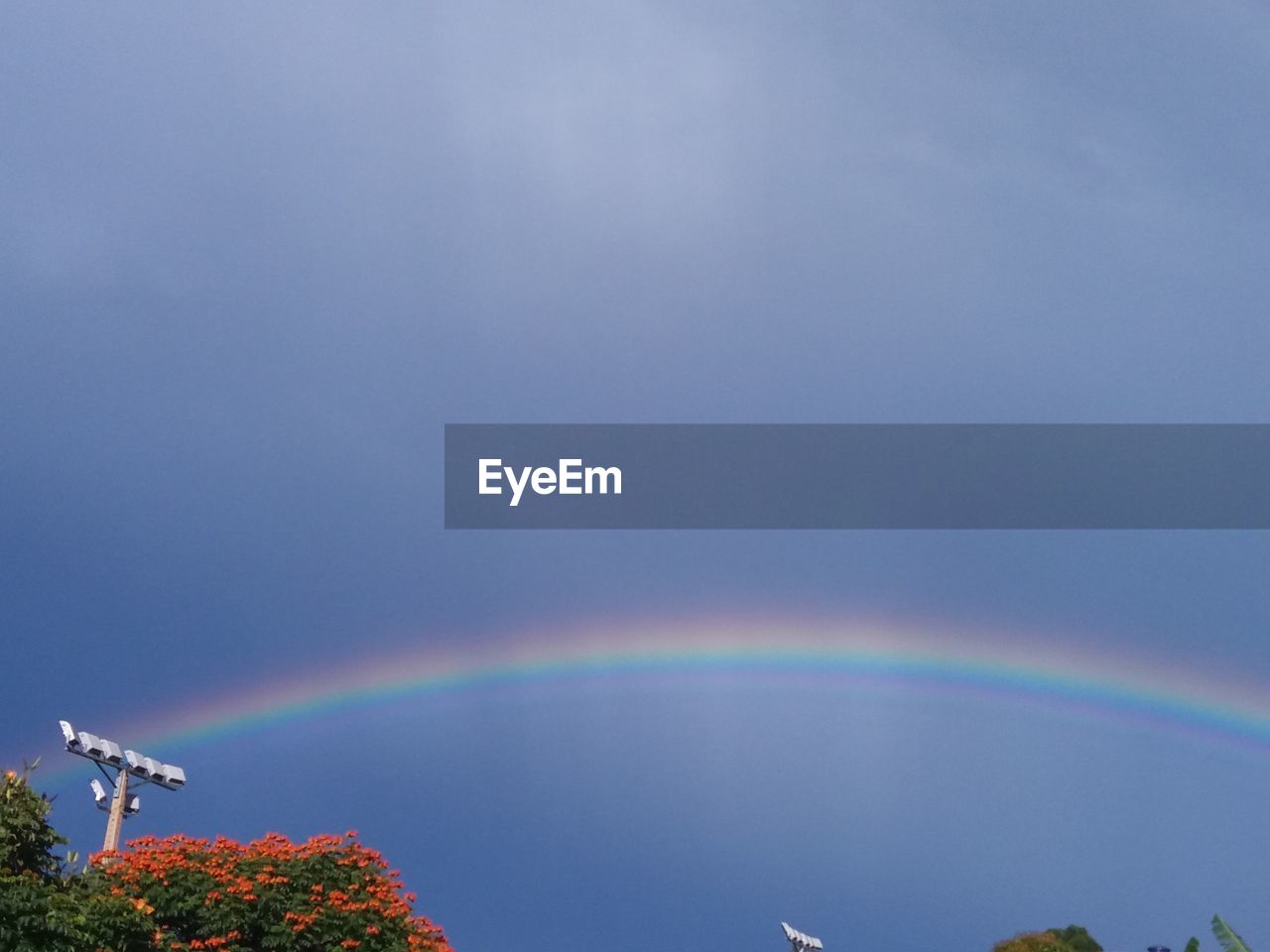 LOW ANGLE VIEW OF RAINBOW IN SKY